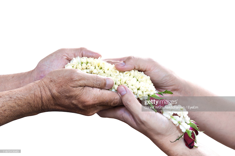 Cropped Image Of People Holding Gajra